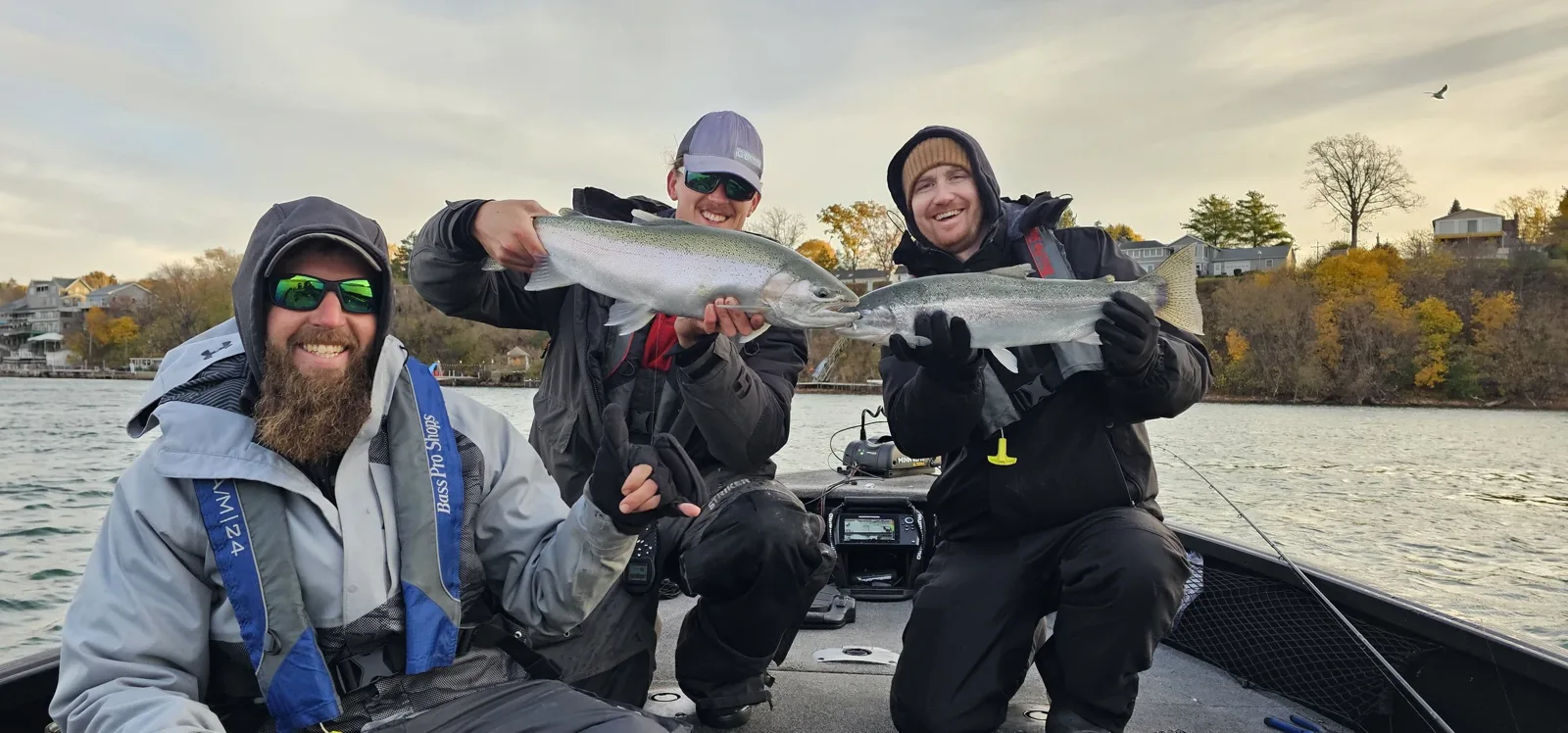 Crew holding steelhead trout aboard the 21-foot Alumacraft sled in fall