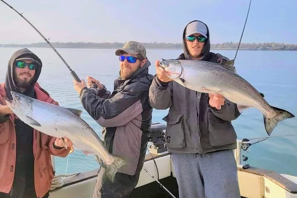 Three anglers with two chinook salmon aboard King Slayer