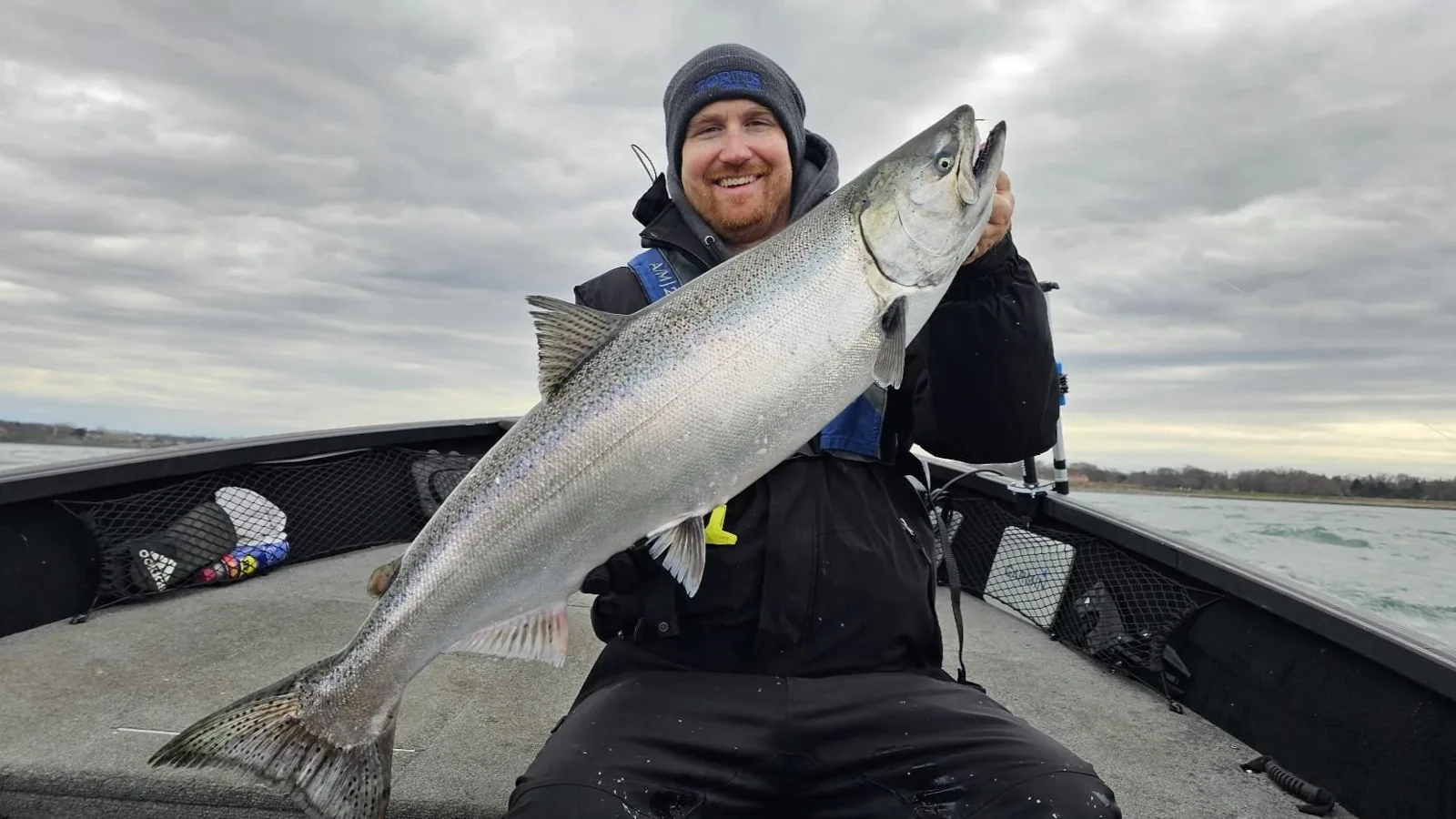 Angler holding a steelhead aboard the Alumacraft on the Niagara River