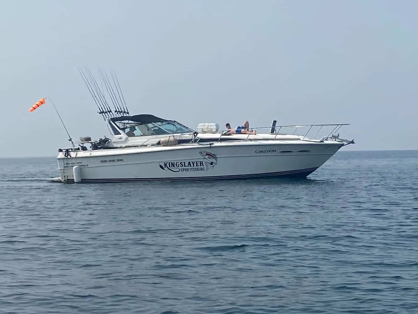 Kingslayer 1 running broadside on Lake Ontario with the King Slayer Sportfishing name on the hull