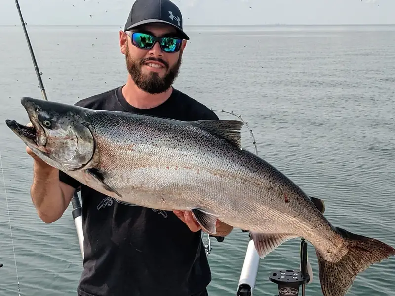 Captain Connor Ivanchuk holding a chinook salmon