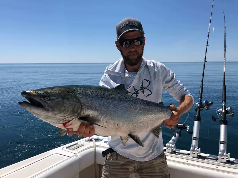 Captain Lucas Dracz holding a chinook salmon
